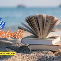 books on a beach near the ocean.