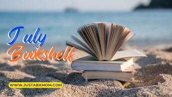 books on a beach near the ocean.
